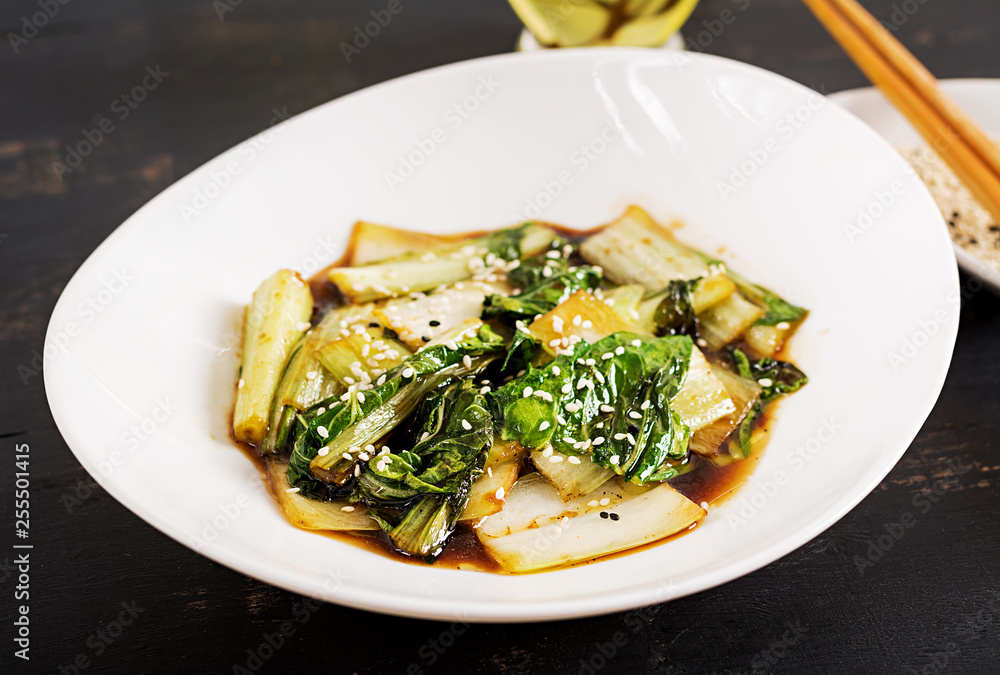 Bok choy vegetables stir fry with soy sauce and sesame seeds. Chinese cuisine. Bok choy vegetables stir fry with soy sauce and sesame seeds. Chinese cuisine.