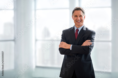 Confident and happy businessman standing with arms crossed, handsome successful smiling portrait, copy space