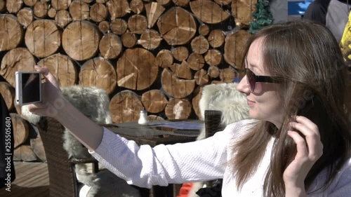 Smiling young woman taking a winter selfie. shymbulak, almaty, kazakhstan.