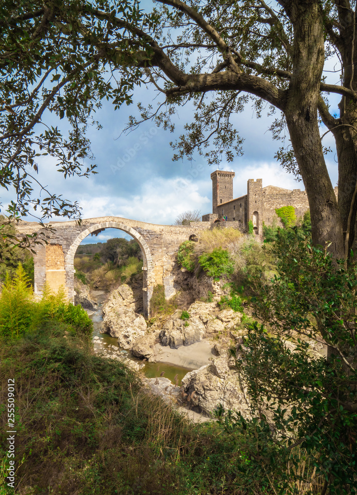 Vulci (Italy) - The medieval castle of Vulci, now museum, with Devil's bridge. Vulci is an etruscan ruins city in Lazio region, on the Fiora river between Montalto di Castro and Canino.