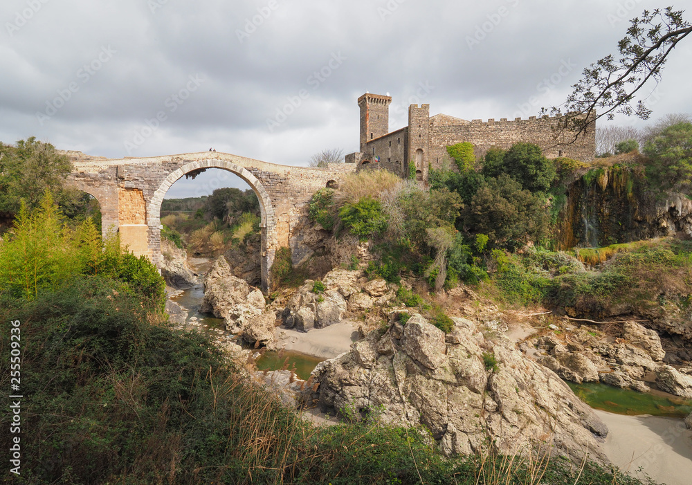 Vulci (Italy) - The medieval castle of Vulci, now museum, with Devil's bridge. Vulci is an etruscan ruins city in Lazio region, on the Fiora river between Montalto di Castro and Canino.