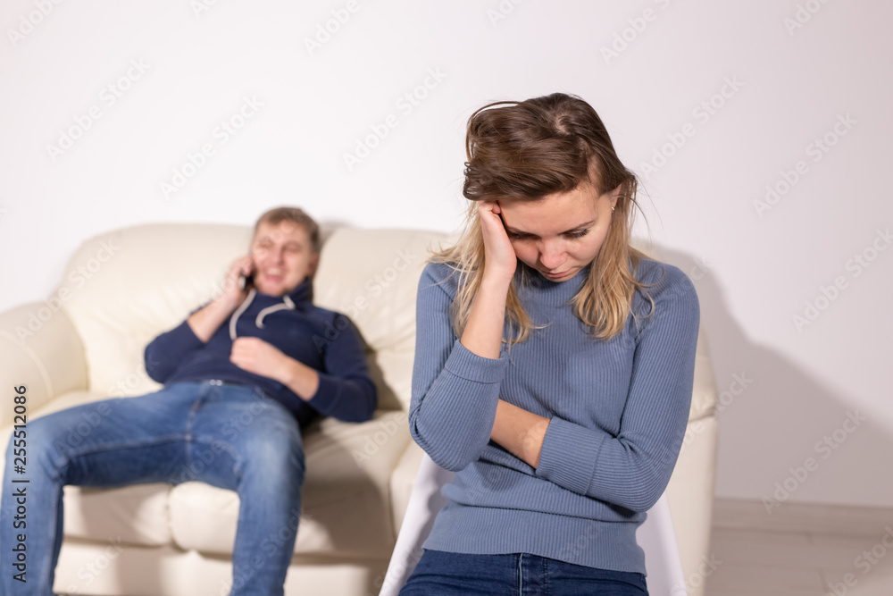 domestic violence, abuse and family concept - crying woman and her husband on the background domestic violence, abuse and family concept - crying woman and her husband on the background
