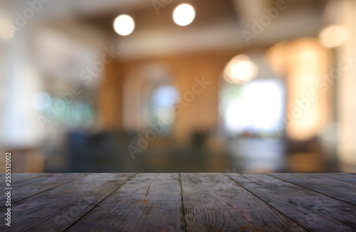 Empty wooden table in front of abstract blurred background of restaurant, cafe and coffee shop interior. can be used for display or montage your products - Image.