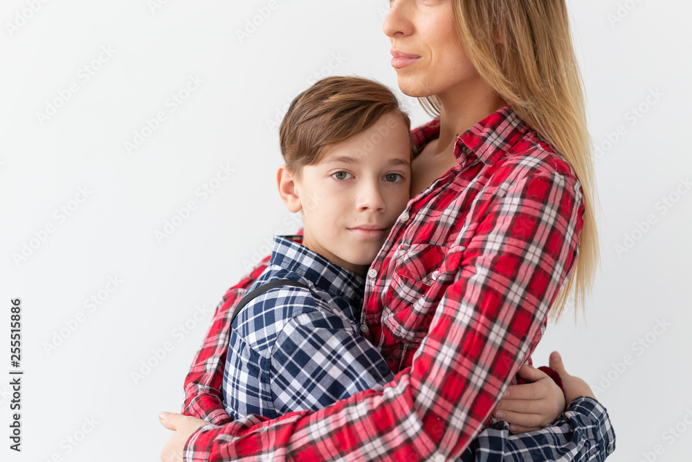 Mothers day, children and family concept - Beautiful woman and her son on white background Mothers day, children and family concept - Beautiful woman and her son on white background