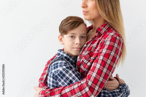 Mothers day, children and family concept - Beautiful woman and her son on white background