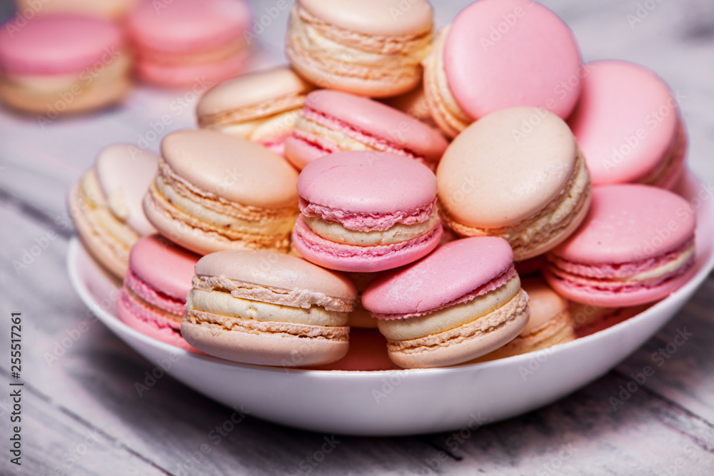 Macaron cookies in white bowl Sweet and colorful french macaroons Close up colorful macarons dessert with vintage pastel tones Macaron cookies in white bowl Sweet and colorful french macaroons Close up colorful macarons dessert with vintage pastel tones