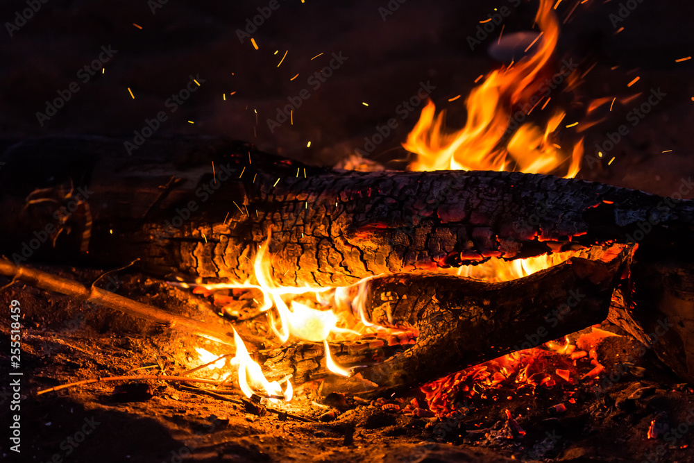 Night, tourism and nature concept - burning log and fire Night, tourism and nature concept - burning log and fire