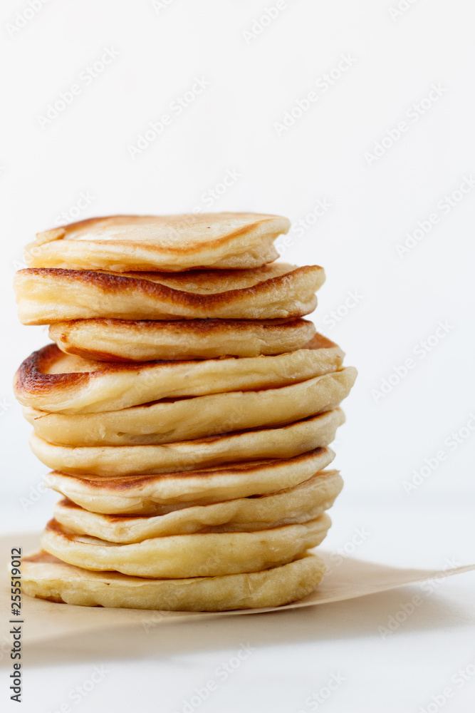 Stack of plain pancakes оn white background with free space for design and text Stack of plain pancakes оn white background with free space for design and text
