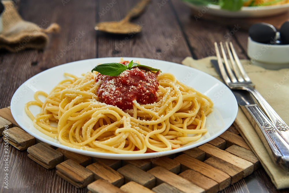 Tasty colorful appetizing cooked spaghetti italian pasta with tomato sauce bolognese and fresh basil. 