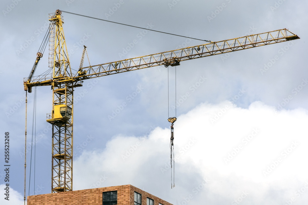 Large construction cranes working on a building complex. Space for text.