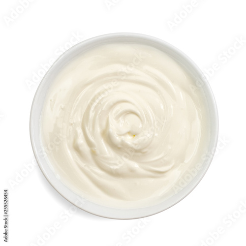 Sour cream in bowl, mayonnaise, yogurt, isolated on white background. Top view.