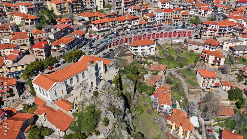 Naklejka premium Aerial drone photo from famous and picturesque village of Arachova built on the slope of Parnassus mountain with traditional character at spring, Voiotia, Greece