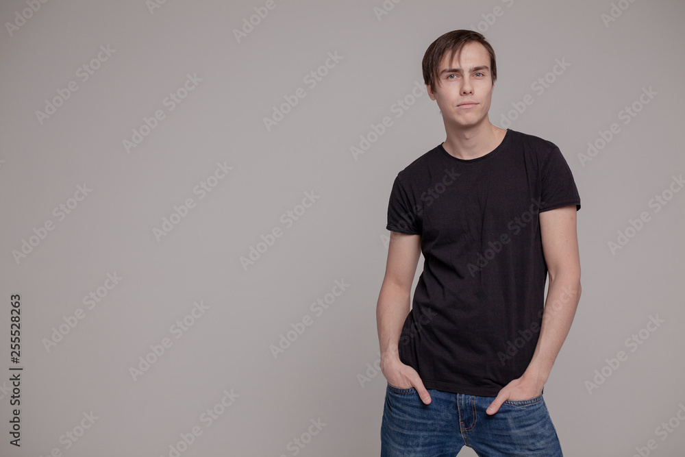 White young man in a black T-shirt and jeans. Emotion. White young man in a black T-shirt and jeans. Emotion.