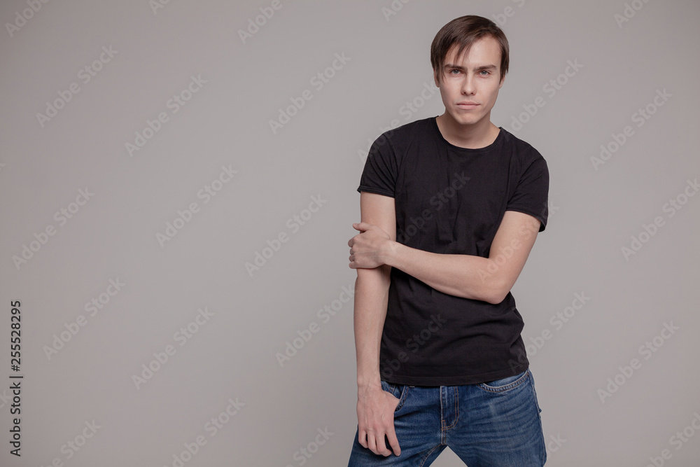 White young man in a black T-shirt and jeans. Emotion. White young man in a black T-shirt and jeans. Emotion.