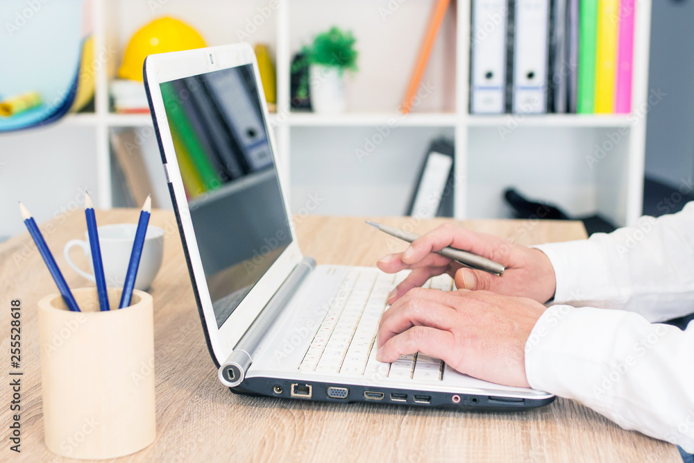 successful businessman working on laptop with financial data at the workplace in a modern office successful businessman working on laptop with financial data at the workplace in a modern office