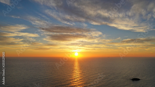 Aerial drone panoramic photo of beautiful sunset over the Aegean sea with golden colours, Greece