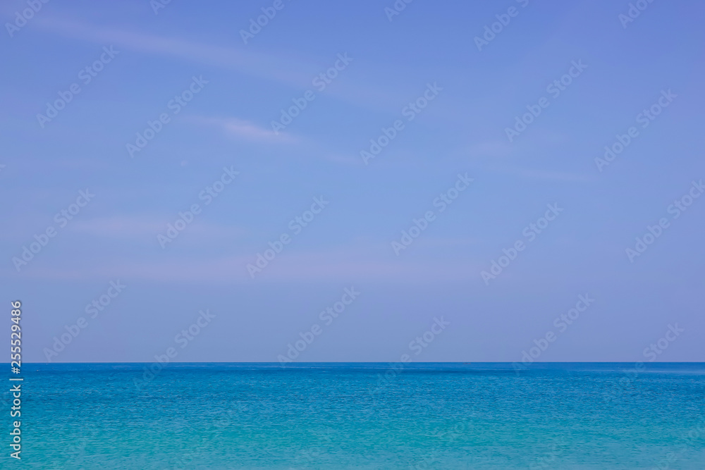 Beautiful white clouds on blue sky over calm sea with sunlight reflection, Tranquil sea harmony of calm water surface. Sunny sky and calm blue ocean. Vibrant sea with clouds on horizon