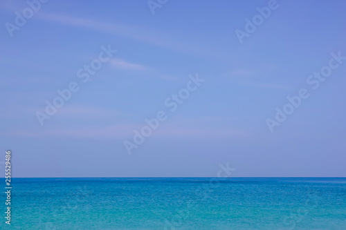 Beautiful white clouds on blue sky over calm sea with sunlight reflection, Tranquil sea harmony of calm water surface. Sunny sky and calm blue ocean. Vibrant sea with clouds on horizon