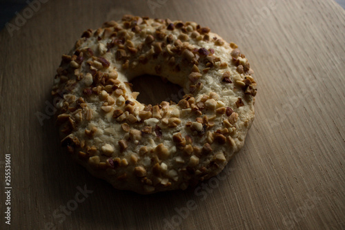 Whole grain cereal shortbread biscuits cookies stacked with nuts. Wooden background