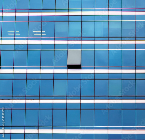 Canvastavla The glass facade of skyscraper with many identical windows and only one window is different