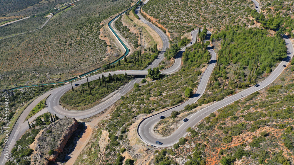 Aerial drone top view photo of snake curvy winding road built in steep mountain slope Aerial drone top view photo of snake curvy winding road built in steep mountain slope