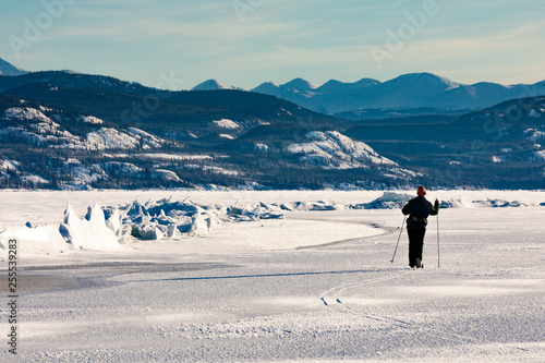 Skier at pressure ridge on Lake Laberge YT Canada