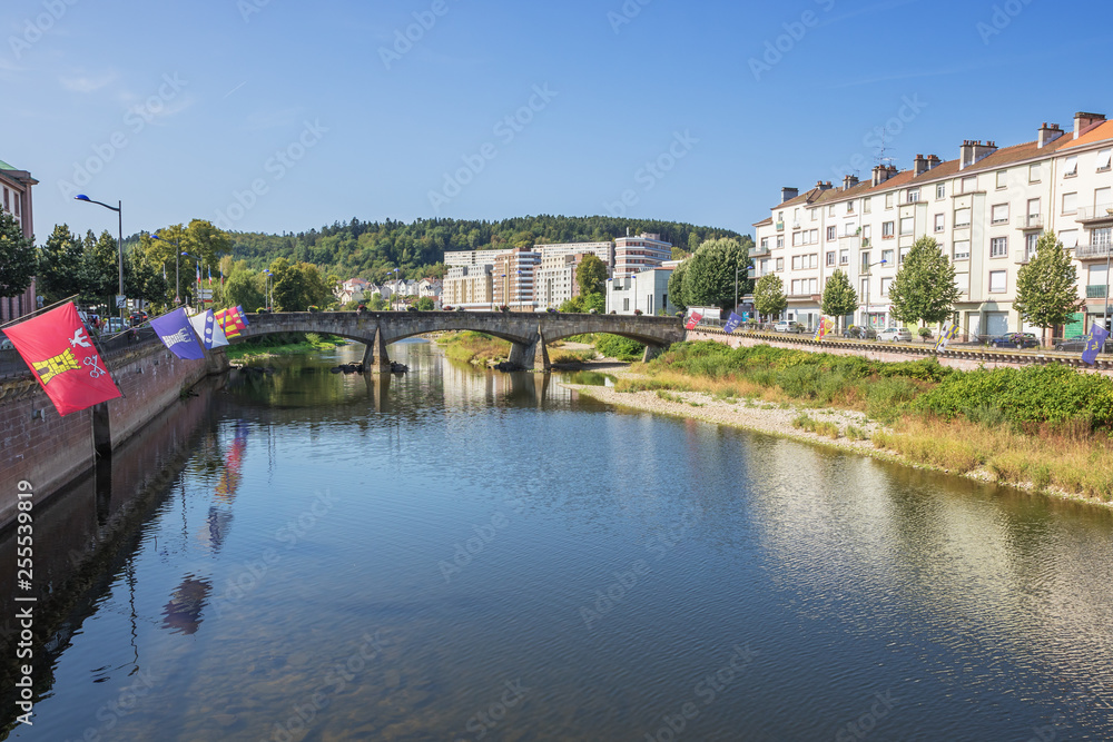The Moselle flowing through Epinal with flags on both shores