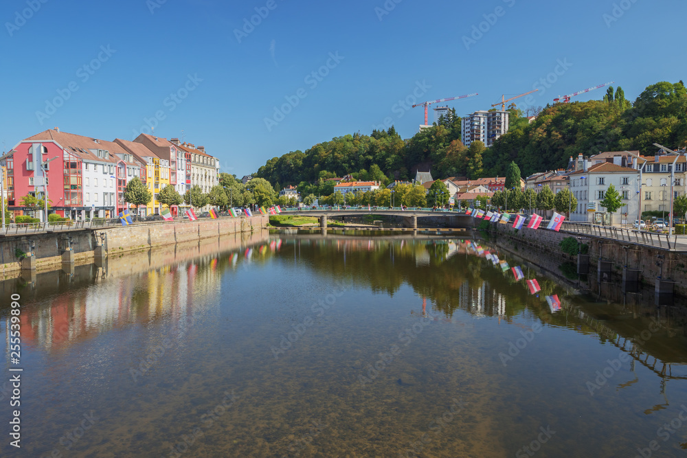 Fototapeta premium The Moselle in Epinal with flags on both shores
