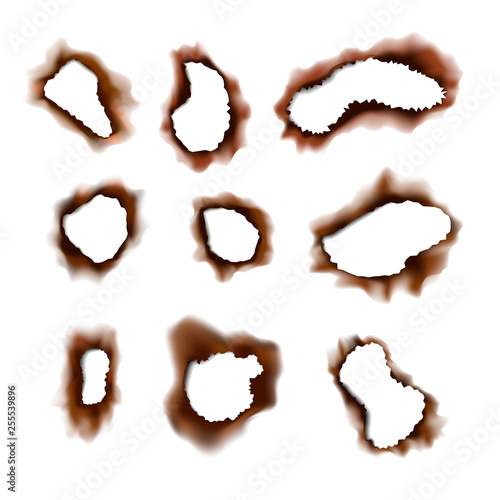 Set of burned torn holes in paper on white