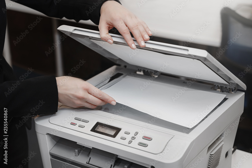 Woman's hand with working copier Woman's hand with working copier