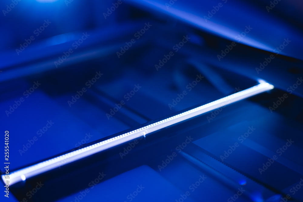 Copier scanner with a bright light inside. Office hazards concept