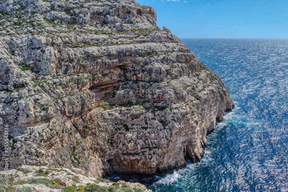 Views of rocky coast on a sunny day with blue sky, Malta