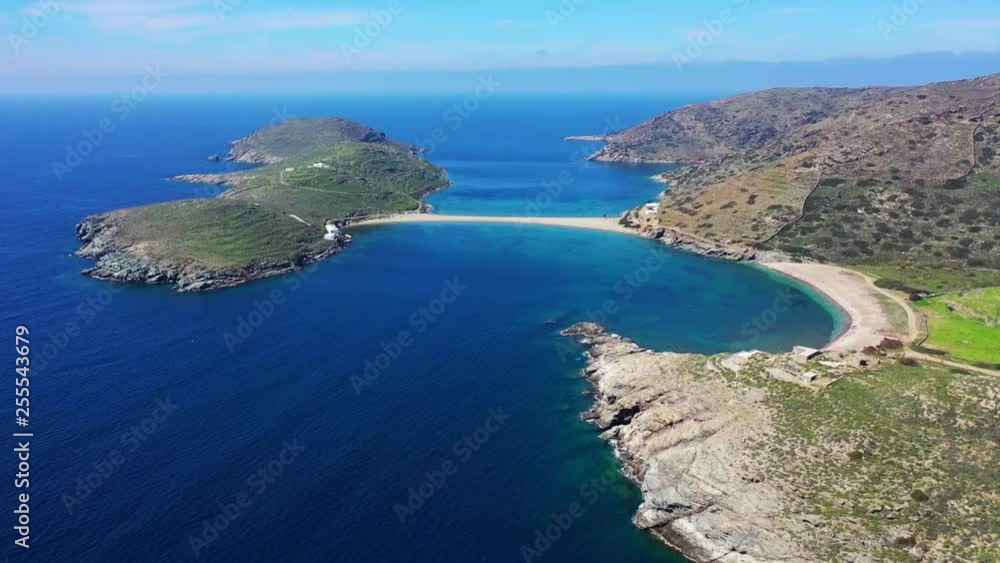 Aerial drone video of iconic two sided sandy tropical turquoise sea paradise beach of Kolones near Fykiada in island of Kythnos at spring, Cyclades, Greece Aerial drone video of iconic two sided sandy tropical turquoise sea paradise beach of Kolones near Fykiada in island of Kythnos at spring, Cyclades, Greece