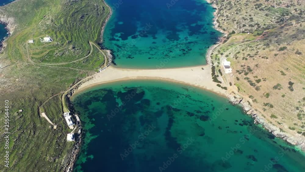 Aerial drone video of iconic two sided sandy tropical turquoise sea paradise beach of Kolones near Fykiada in island of Kythnos at spring, Cyclades, Greece Aerial drone video of iconic two sided sandy tropical turquoise sea paradise beach of Kolones near Fykiada in island of Kythnos at spring, Cyclades, Greece