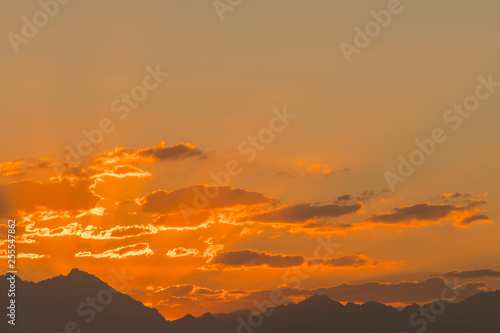 Sunset mountain peaks sky. Mountain peaks sunset view. Mountain sunset sky clouds