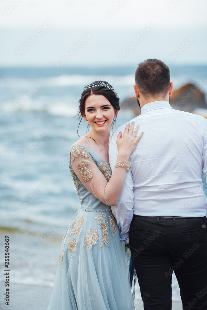 same couple with a bride in a blue dress walk same couple with a bride in a blue dress walk