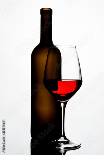 bottle of red wine and glass isolated on white background