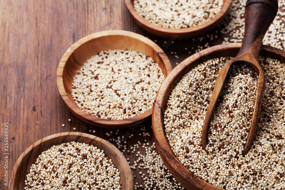 Mixed quinoa in bowl on wooden kitchen table. Healthy and diet superfood product. Mixed quinoa in bowl on wooden kitchen table. Healthy and diet superfood product.