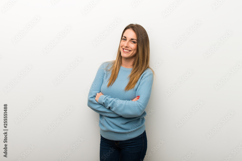 Blonde woman on isolated white background keeping the arms crossed in frontal position Blonde woman on isolated white background keeping the arms crossed in frontal position