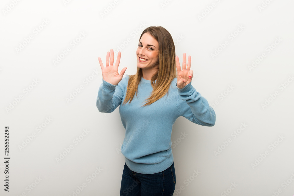 Blonde woman on isolated white background counting eight with fingers Blonde woman on isolated white background counting eight with fingers