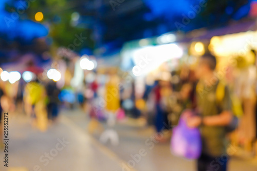 Abstract blurred people walking on market with light of bokeh