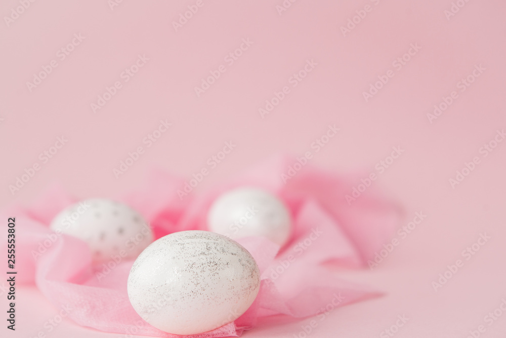 White Easter eggs on pink background with copy space. Top view shot of arrangement decoration Happy Easter holiday background concept. Design pastel tone in minimal flat lay