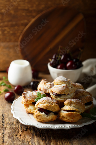Choux pastry buns with custard and cherry