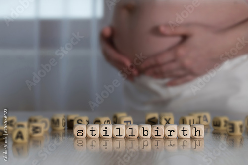 Word STILLBIRTH composed of wooden letters.