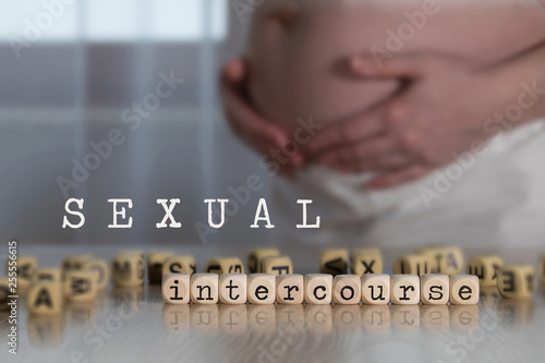 Obraz na plátně Words SEXUAL INTERCOURSE  composed of wooden letters.