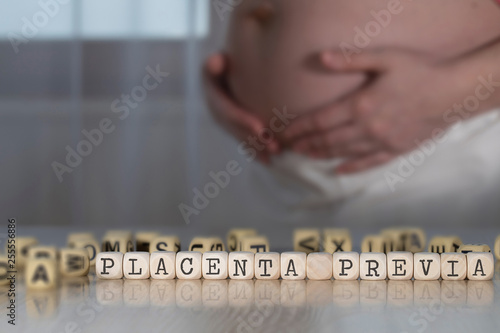 Words PLACENTA PREVIA composed of wooden letters.