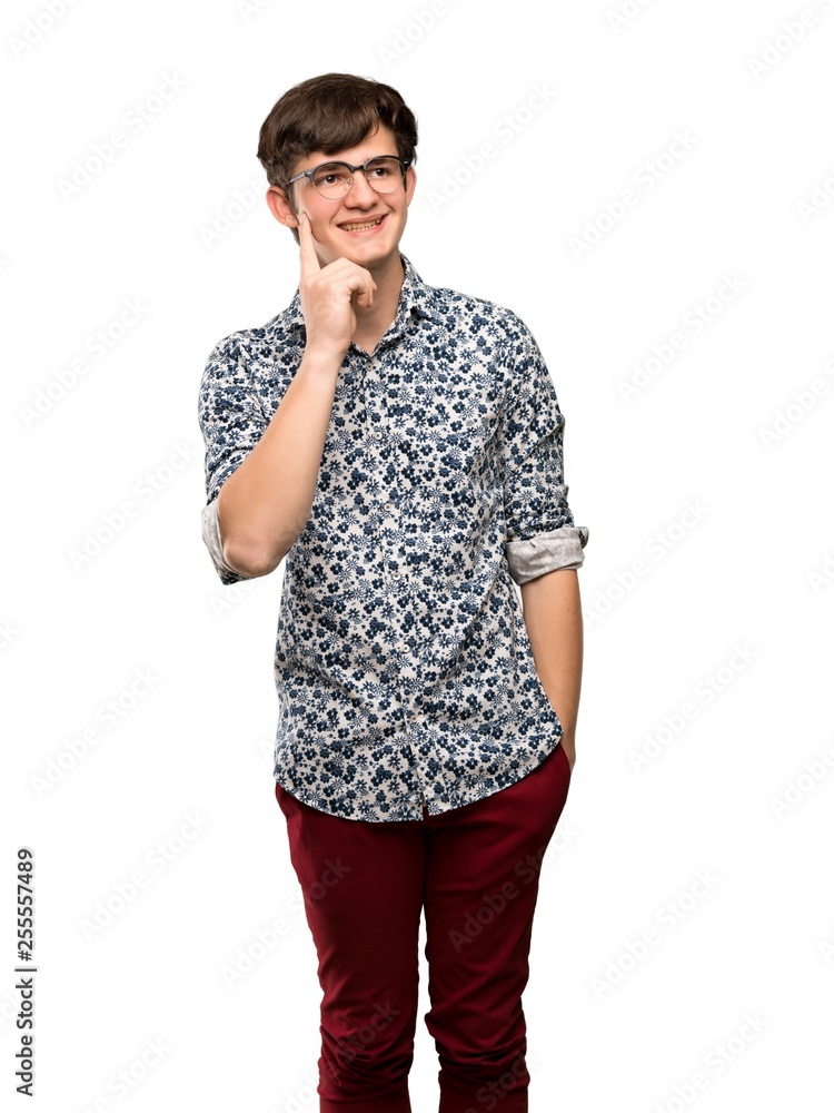 Teenager man with flower shirt and glasses thinking an idea while looking up over isolated white background Teenager man with flower shirt and glasses thinking an idea while looking up over isolated white background
