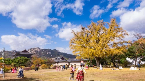 Time lapse of Gyeongbokgung palace in Autumn and girls in Hanbok clothes.