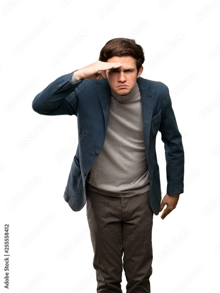 Teenager man with turtleneck looking far away with hand to look something over isolated white background Teenager man with turtleneck looking far away with hand to look something over isolated white background