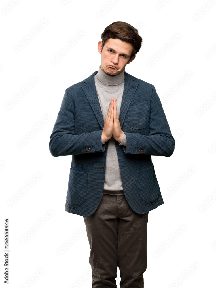 Teenager man with turtleneck keeps palm together. Person asks for something over isolated white background Teenager man with turtleneck keeps palm together. Person asks for something over isolated white background